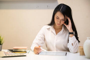 Cropped shot of two UI developers meeting on their project with paperwork and tablet on meeting...