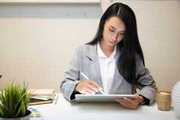 Cropped shot of two UI developers meeting on their project with paperwork and tablet on meeting...
