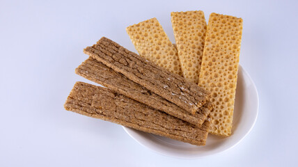 fitness crispbreads lie in a white plate, isolated