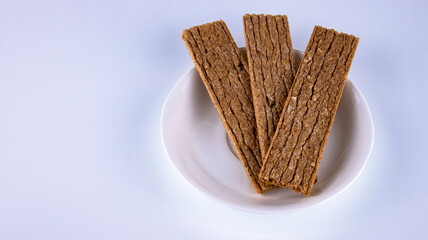 fitness crispbreads lie in a white plate, isolated