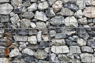 Gabion wall constructed with steel cage and crushed limestone rock.