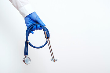 Medicine doctor with stethoscope in hand over white background, copy space. Medicine clinic service.