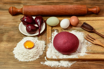 Purple dough bun for noodles with ingredients on the table.