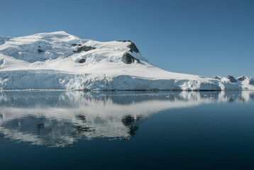 Fototapeta na wymiar Snowy mountains in sunny day, Paraiso Bay, Antartica.