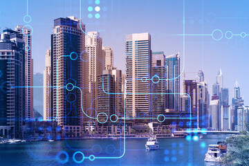 Skyscrapers of Dubai business downtown. International hub of trading and financial services. Technology theme icons hologram, concept of big data. Double exposure. Dubai Canal waterfront.