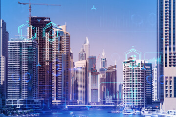 Skyscrapers of Dubai business downtown. International hub of trading and financial services. Technology theme icons hologram, concept of big data. Double exposure. Dubai Canal waterfront.