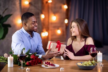 Gift For You. Loving African Guy Greeting Girfriend With International Women's Day
