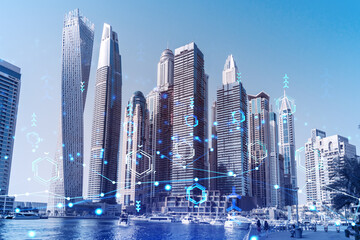 Skyscrapers of Dubai business downtown. International hub of trading and financial services. Technology theme icons hologram, Fintech concept. Double exposure. Dubai Canal waterfront.