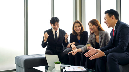 2021 Target Plan Meeting between coffee break on sofa. Group of business people in suit discuss...
