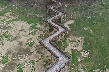 A winding walkway in the park's grass reaches into the distance