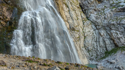 The huge Gegsky waterfall gushing with a strong stream from the rock in the vastness of Abkhazia