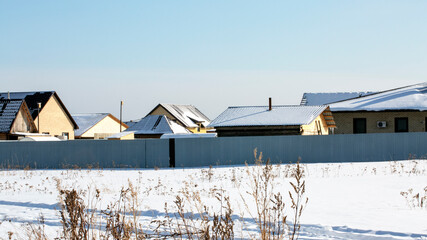 Fototapeta na wymiar Village in the winter. Houses in the village. Winter landscape