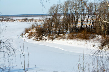 Snowy winter forest river scene. Landscape with trees. Trees along the shore. Winter landscape