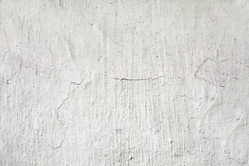 White stucco wall with cracks. Background, texture.