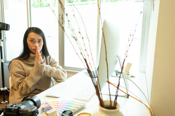Cropped shot of two UI developers meeting on their project with paperwork and tablet on meeting...