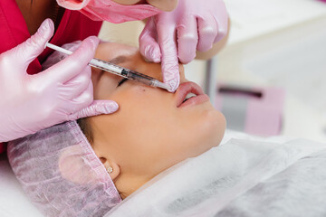 Cosmetology procedure for lip augmentation and wrinkle removal for a young beautiful girl....