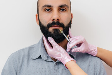Cosmetic procedure for lip augmentation and wrinkle removal for a bearded man. Cosmetology