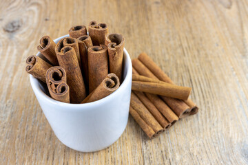 close-up of cinnamon  stick inside a white cup of coffee