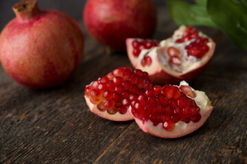 Fresh ripe pomegranate on a wooden background, selective focus