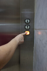 man hand pressing elevator button