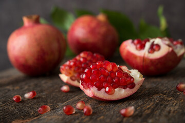 Fresh ripe pomegranate on a wooden background, selective focus