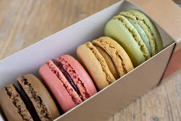 fresh colorful macarons lined up in box