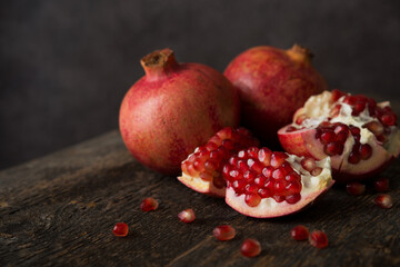 Fresh ripe pomegranate on a wooden background, selective focus