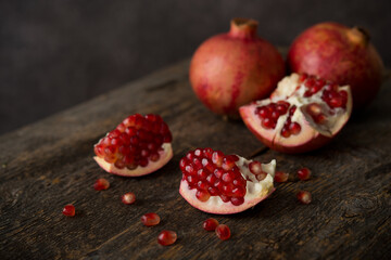 Fresh ripe pomegranate on a wooden background, selective focus