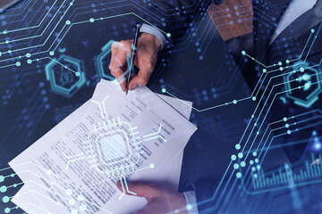 A client in dark blue suit is signing a contract to create a new software to present it in start up conference and gain investments to create a product. Technological graph over the desk.