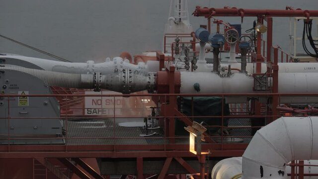 Cold vapour of LNG flange connection on cargo manifold of gas tanker in twilight