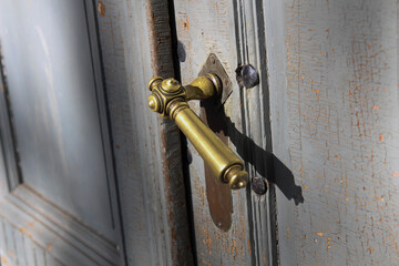 Old. Natural light. Manor House. Vintage wooden door with old metal door handle knocker