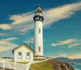 Pigeon Point lighthouse against the backdrop of a beautiful sky and ocean with waves, a great landscape of the Pacific coast in California