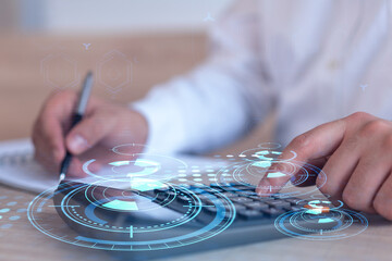 A research and development specialist computing the data to create a new approach to develop high tech business. Technological icons over the desk with calculator.