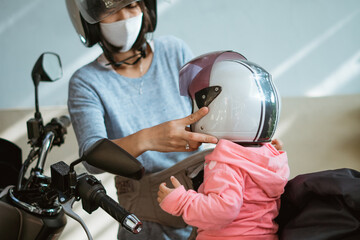 wear a helmet for the safety of young children before going out on a motorbike