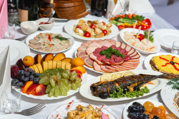 Table setting, food and decorations for important and family events, delicious snacks and hot dishes.