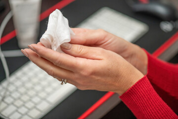 Woman cleaning hands at home in pandemic time