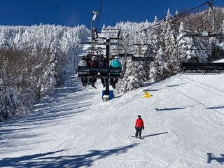 Fototapeta na wymiar Ski chair lifts at Okemo mountain ski resort at sunny winter day in Vermont USA