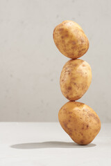 Whole potato balanced on a table.