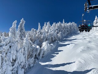 Ski chair lifts at Okemo mountain ski resort at sunny winter day in Vermont USA