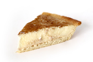 Traditional South African milk tart slice isolated on white background
