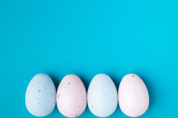 Easter eggs on a blue background, blank for design with copy space