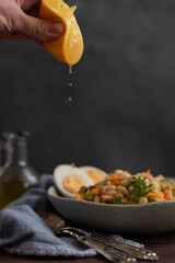 Squeeze lemon over cooked bean salad