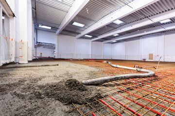 Concrete screed on floor heating in a new warehouse and office building