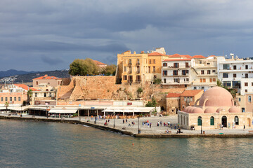 Fototapeta na wymiar Beautiful town of Chania and its old port with the old mosque at the right, (now an arts center), a popular tourist resort in Crete, Greece, Europe