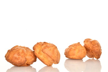 Several fresh fragrant chouquettes, on a white background.