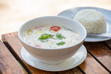 Thai coconut cream soup in bowl, close up