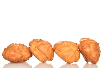 Several fresh fragrant chouquettes, on a white background.