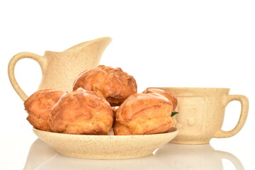 Several sweet shukets with a cup and saucer made of ceramics, close-up, on a white background.