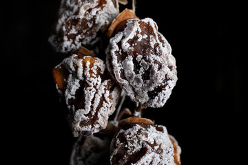 sugar dried persimmon on a dark background