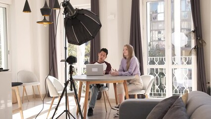 Young happy friends sharing content on streaming platform with camera - Modern marketing concept with millenial couple